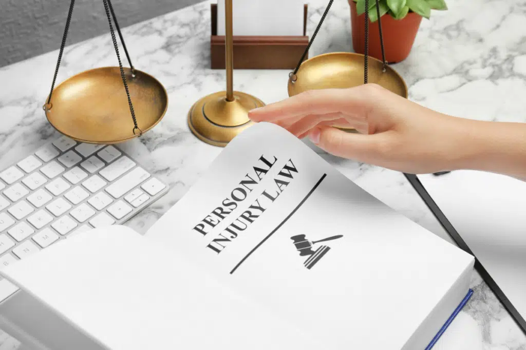 personal injury law book and justice scale