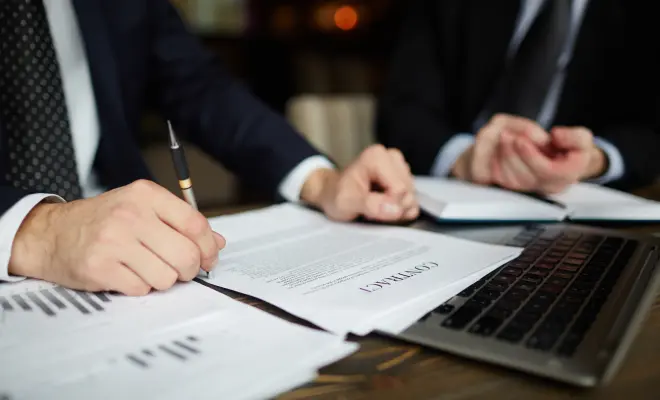 business partners signing a contract