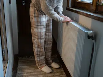 A person looking out the window in winter