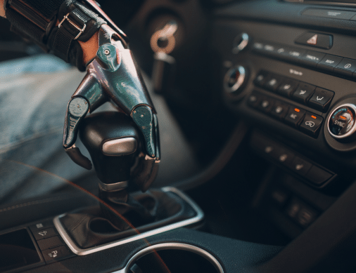 Young disabled man driver with artificial prosthetic hand driving vehicle car.