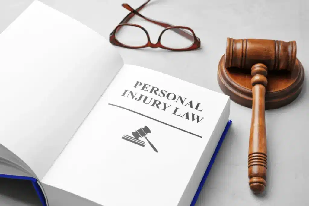 Personal injury law book, Gavel and Glasses on a table