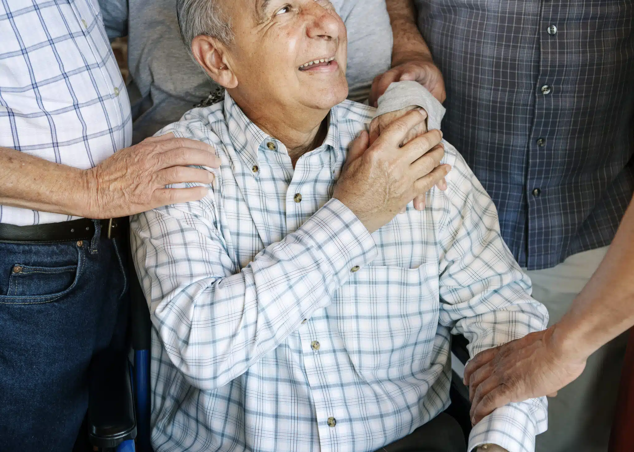 Elderly men cheer up his friend on a wheelchair