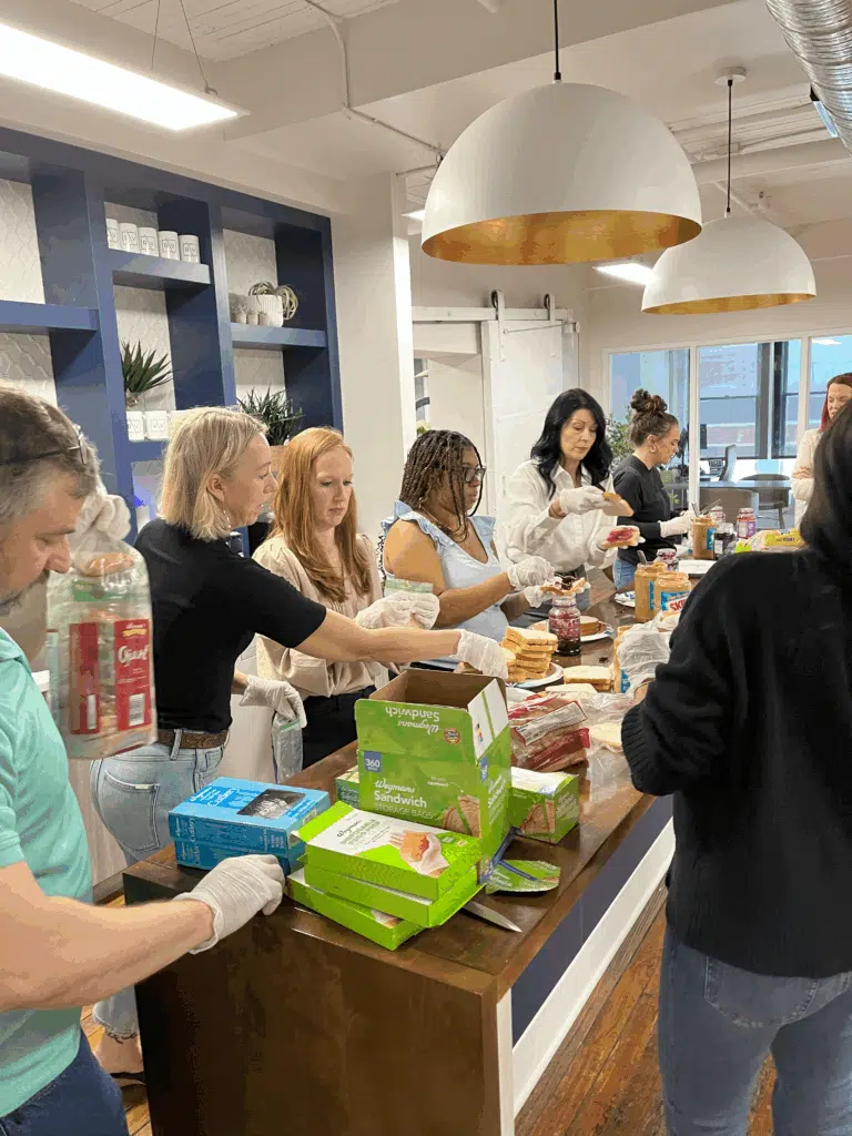 Group of people working together at a table during a community outreach activity