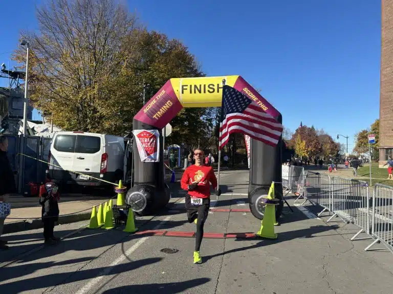 Runner crossing the finish line during a community outreach race