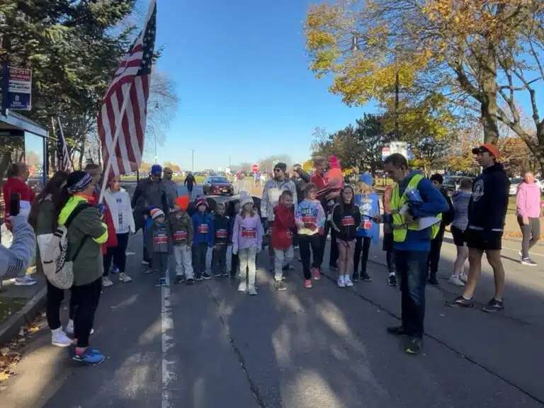 Families and children gathered at the start of a community outreach race