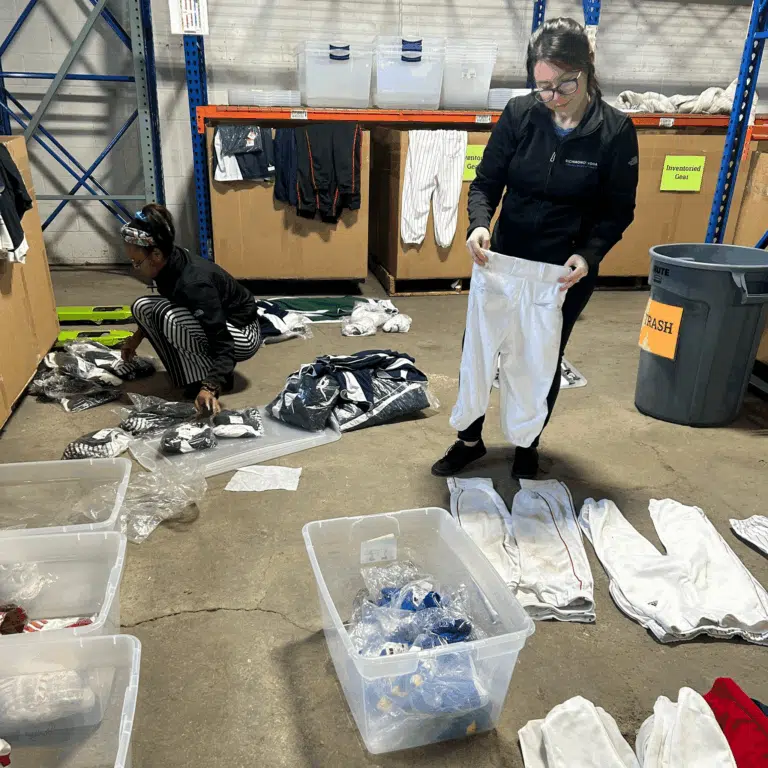 Woman sorting donated clothing during a community outreach event