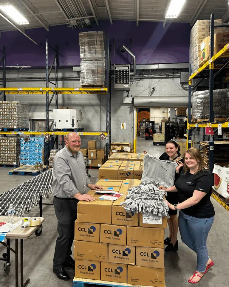 Volunteers standing by stacked boxes during a Richmond Vona community outreach