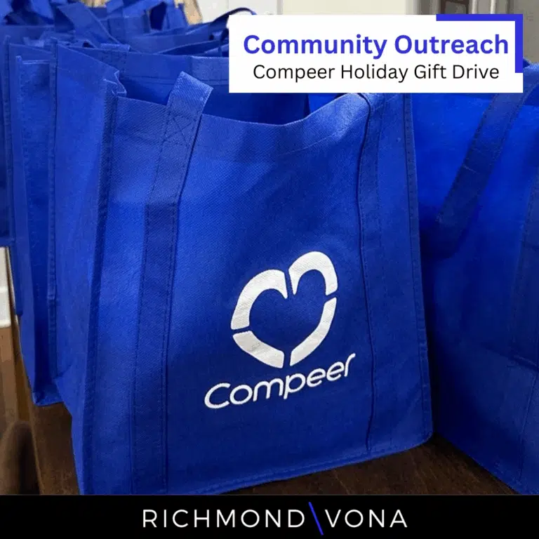 Blue Compeer tote bags lined up for the Richmond Vona Holiday Gift Drive.