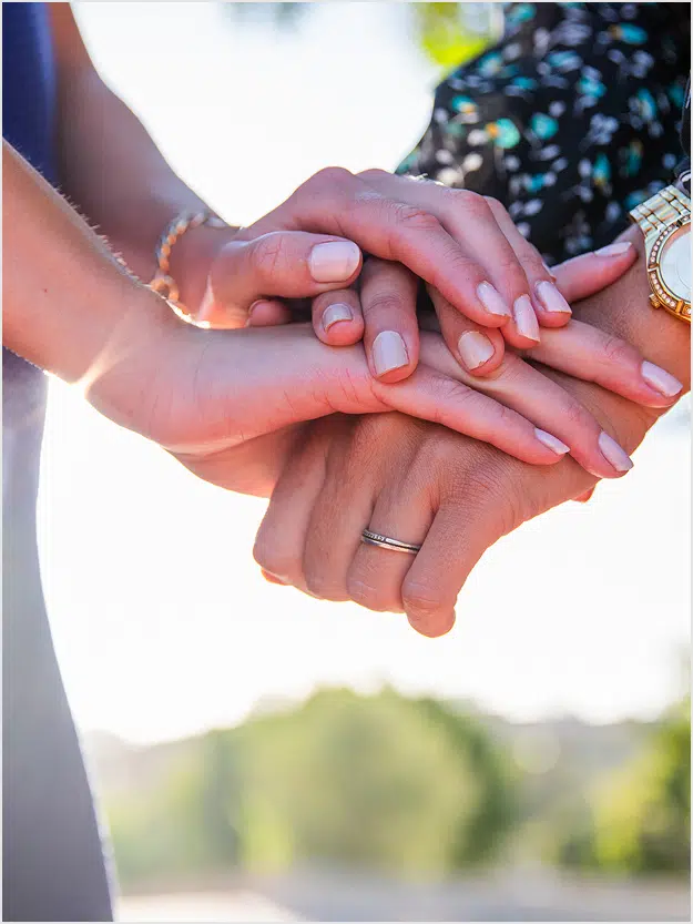 Hands placed one above the other as a sign of support, help and compassion