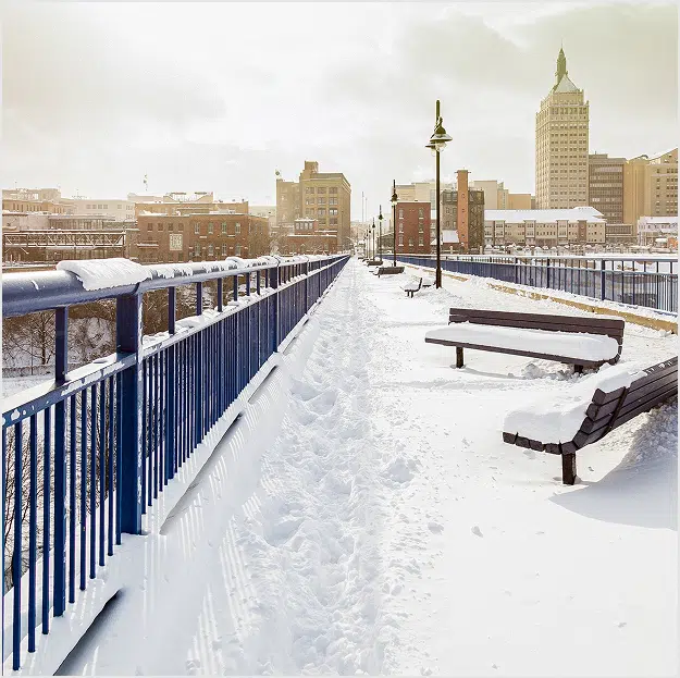 Beautiful shot of benches covered with snow at High Falls, Rochester, New York