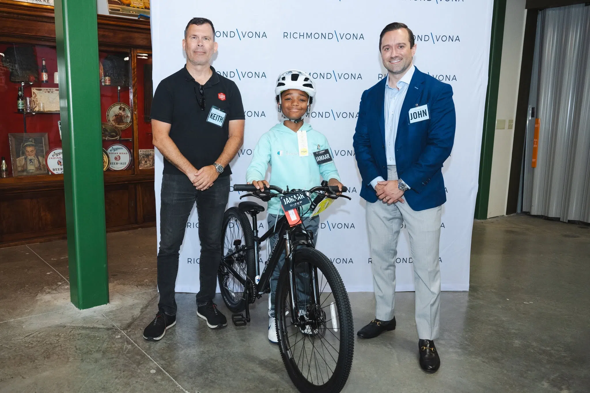 John Richmond and Keith Vona with one of the 2026 Richmond Vona Bike Giveaway Winners