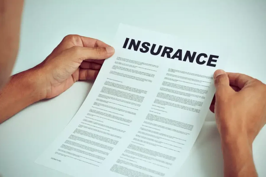 A man hoding an insurance paper