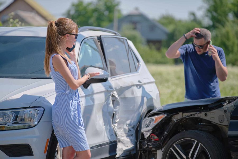 Drivers of smashed vehicles talking on cellphone calling for help in car crash accident on street side. Road safety and insurance concept Drivers of smashed vehicles talking on cellphone calling for help in car crash accident on street side. Road safety and insurance concept