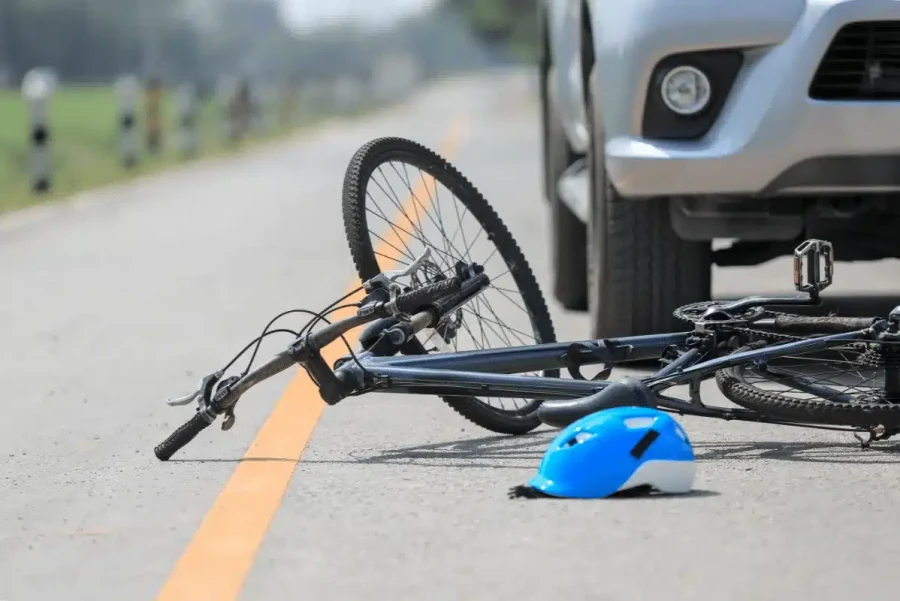 Bicycle and helmet on the road after a collision with a car